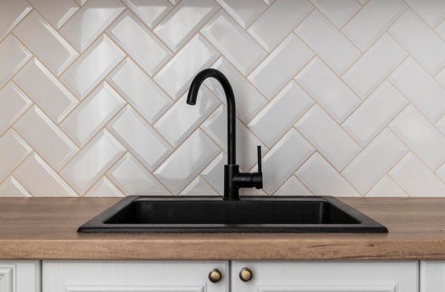 Detailed kitchen backsplash installation with clean tile alignment.
