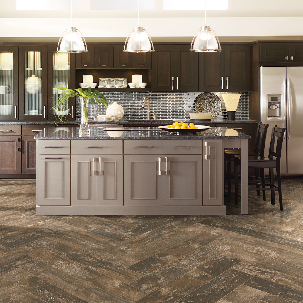 Bright finished kitchen with white cabinetry, a large island, and warm wood flooring.