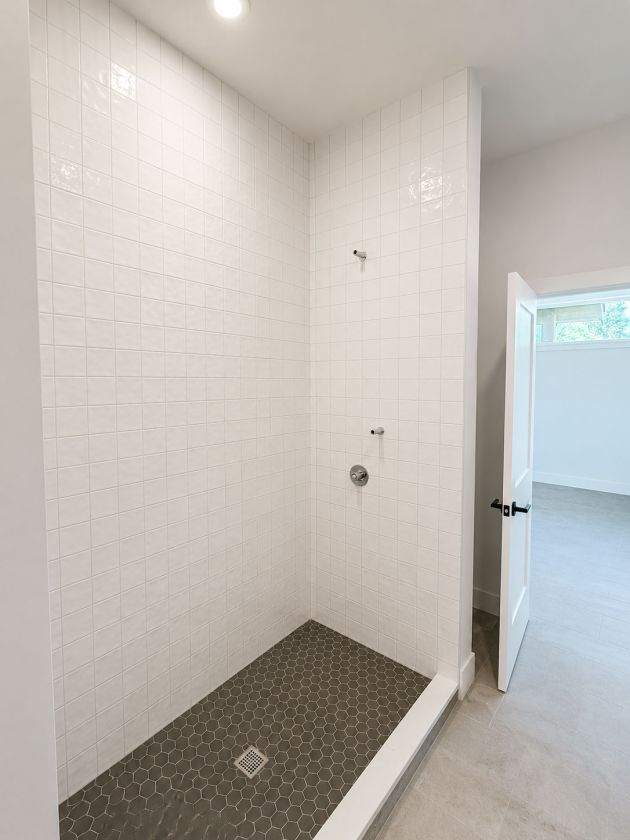 White tile shower and glass